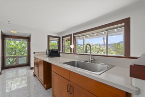 Kitchenette area with sink, counter space, and storage.