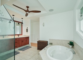 Indulge in your private spa-like bathroom featuring a luxurious soaking tub, walk-in shower, and elegant design details.