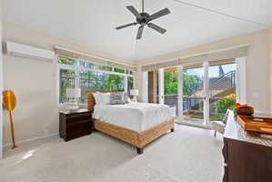 Wake up in this airy bedroom where tropical breezes flow through sliding doors and natural light fills your peaceful retreat.