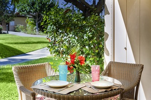 Start your mornings in paradise with coffee on this charming lanai bistro set, surrounded by lush greenery.