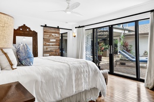 Wake up in your serene bedroom sanctuary, where crisp linens and tropical breezes await through sliding doors to your private lanai.