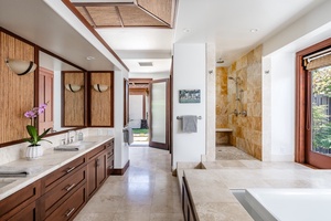 Marble bathroom with shower and jetted tub.