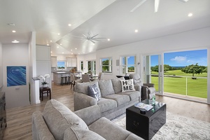 Spacious living room with comfortable seating, abundant natural light, and views of the surrounding golf course.
