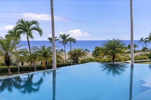 Infinity pool reflects ocean blues and swaying palms for the ultimate Big Island experience.