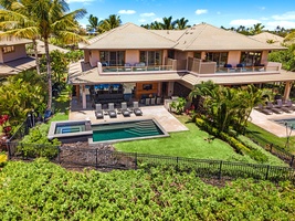 Aerial view of the villa showcasing private pool, lush lawn, and covered lanai.