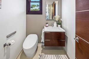A modern powder room with a minimalist design, offering a bright and airy feel.