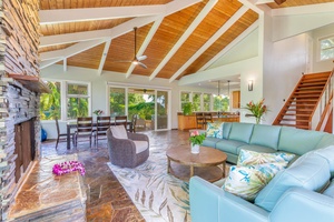 The great room at Pohaku Villa offers vaulted ceilings, plush seating, and dining space that flows naturally outdoors.
