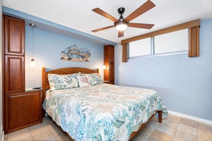 The primary bedroom with a king-sized bed, split AC and ceiling fan.