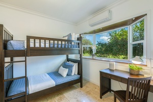 Cozy bunk room featuring twin-over-twin bunks and a study nook, ideal for younger guests.