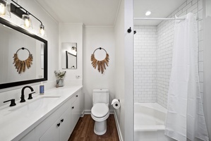 Bathroom featuring a walk-in shower, stylish vanity, and elegant tile accents, combining luxury with functionality.