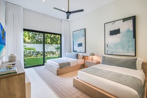 Unwind in a bedroom with modern decor and access to a lush garden.