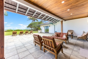 Covered lanai with ocean and lawn views — ideal for morning coffee or evening cocktails.