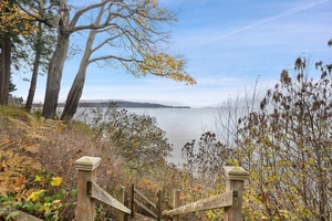 Follow the rustic steps to the tidal shoreline—your private path to peaceful beach strolls and salty sea air.