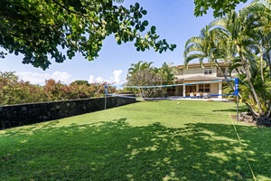 Large, sunlit backyard perfect for family games or peaceful lounging in paradise.