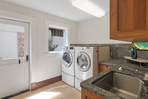 An in-unit laundry room with a washer and a dryer.