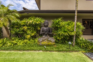 Peaceful garden setting with a Buddha statue, adding a touch of serenity to the lush surroundings.