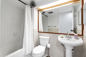 Compact guest bathroom featuring a pedestal sink and clean design.