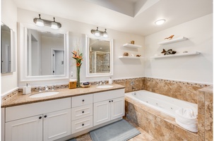 Private ensuite bathroom with dual sinks, a jacuzzi tub, walk-in closet, and separate glass shower