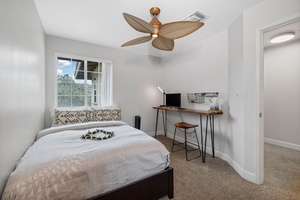Second guest room doubles as a remote-work hub with queen bed and writing desk.
