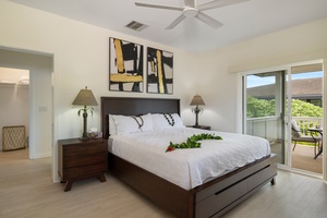 Second guest bedroom with a queen-size bed, tranquil decor, and plenty of natural light.