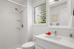 Clean and airy guest bathroom with ocean breeze and thoughtful tropical touches.