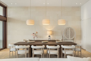 Elegant dining area featuring modern lighting and comfortable seating for ten for memorable gatherings.