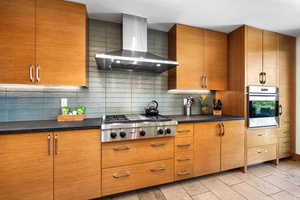 Sleek wood cabinetry and stainless appliances bring function and style to the gourmet kitchen.