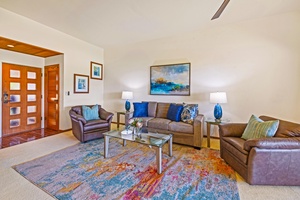 The vibrant living room at Kapalua Ridge 2321 features plush seating and inviting island-inspired decor.