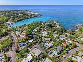 Stunning aerial view of oceanfront community with pristine turquoise waters and tropical landscape.