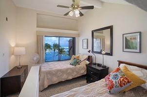 Ocean-view guest bedroom featuring two twin bed.