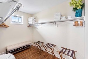 Minimalist laundry room with practical shelving and seating.