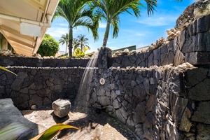 Lava-rock outdoor shower to rinse off after beach or ocean swims.