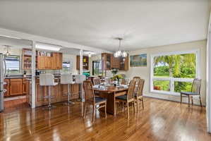 Enjoy a seamless flow between dining and kitchen, with large windows bringing in natural light.