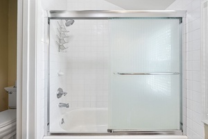 Glass-enclosed shower in the guest bathroom adds convenience and privacy.