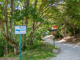 Creekside signs mark your entry into peaceful wooded pathways.