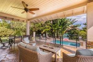 Expansive covered lanai at Pohaku Villa with multiple seating zones for dining and lounging.