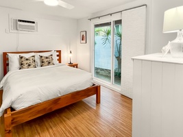 The guest cottage suite features a queen bed and private access to the garden.
