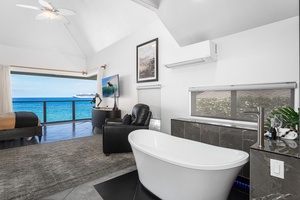 Freestanding tub with panoramic views—relax in true island style from your private ensuite.