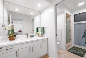 Modern guest bathroom with double vanity, soft lighting, and convenient en-suite layout for relaxed routines.