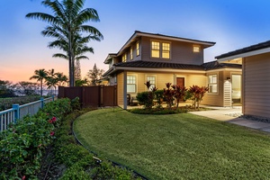 Lush green yard and twilight skies welcome you home.