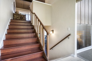 Stairs leading from the entry to the upstairs living and downstairs bedroom
