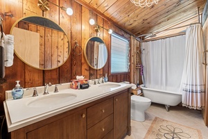Enjoy a rejuvenating soak in the bathroom featuring a clawfoot tub.