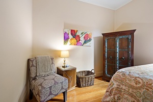 Your cozy reading nook awaits with a plush armchair and warm lamp, perfect for unwinding after exploring the city.