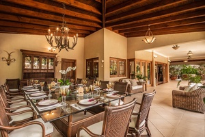 Have a delicious meal in the outdoor dining area with a elegant table arrangement.