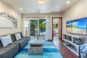 Relax in the cozy secondary living area, a bright space that opens to the outdoors and makes for a peaceful reading or conversation nook.