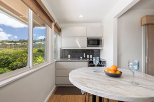 This secondary kitchenette is perfect for snacks or guest meal prep—featuring a microwave, mini fridge, and views of the hills.