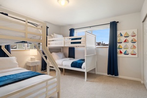 Your family's dream sleep space featuring cheerful nautical décor and cozy bunk beds that promise restful nights for everyone.