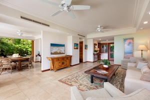 Relax in your spacious open-plan living area with tropical garden views, comfortable seating, and elegant décor.