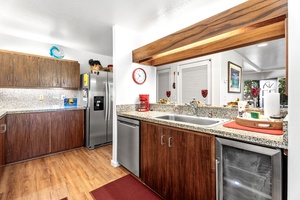 Your fully equipped kitchen features granite countertops, stainless steel appliances, and warm wood cabinetry—perfect for preparing your favorite meals during your stay.