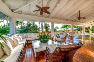Open-air lounge area with comfortable seating and lush greenery.